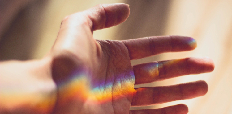 rainbow reflection on hand